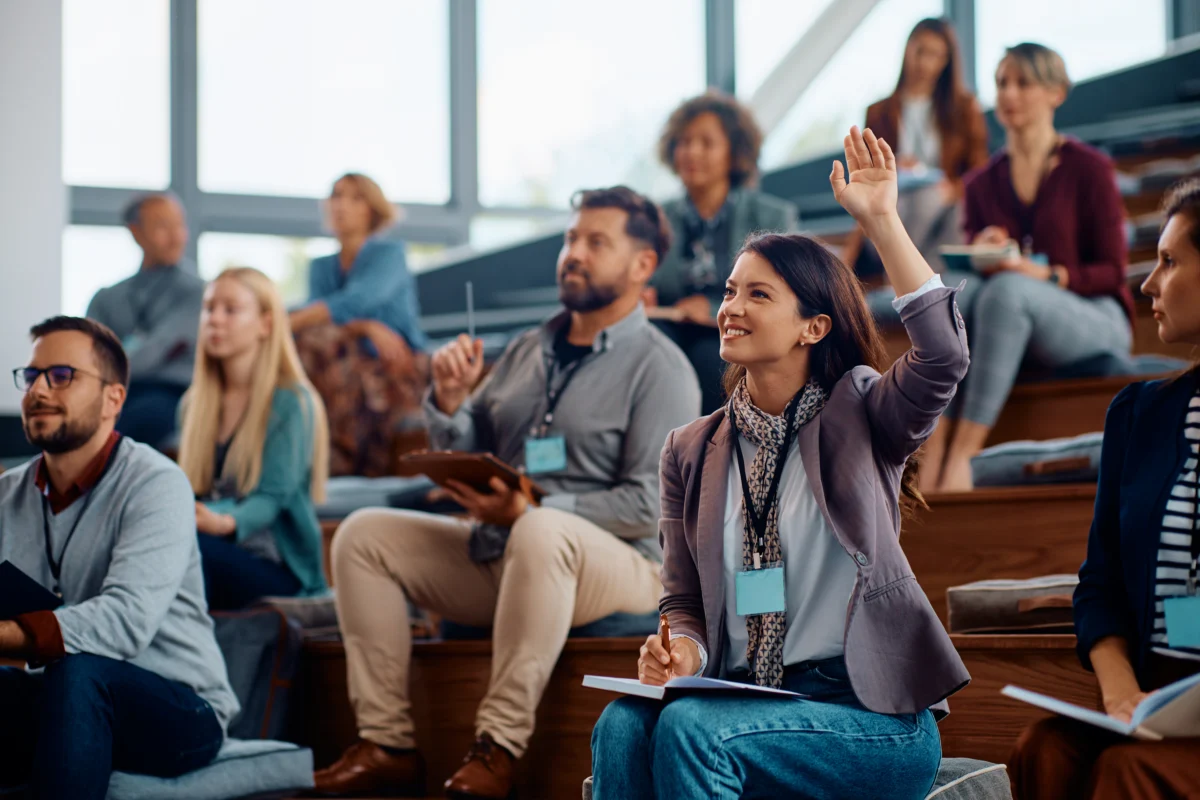 female-entrepreneur-raising-a-hand-to-ask-a-questi-2026-03-16-03-31-03-utc