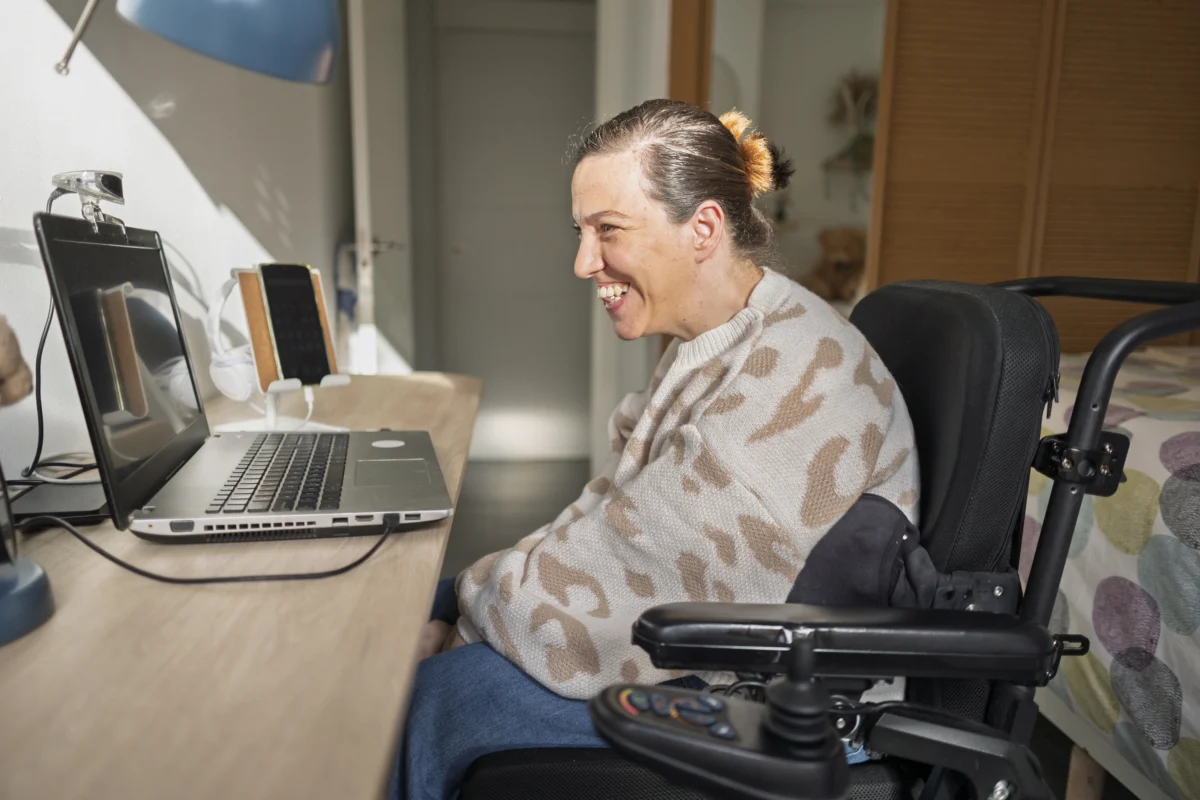 Woman Smiling Using Computer to Talk To Amanda - Branchability - Adapted Recreation Programs